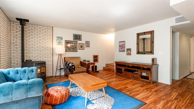 living room with a wood stove and hardwood / wood-style floors