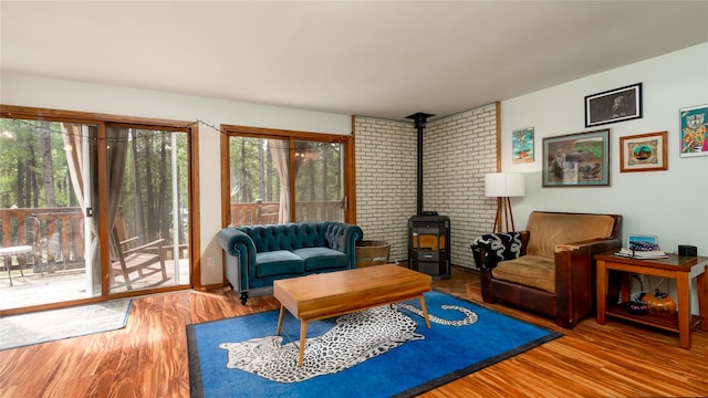 living room with wood-type flooring and a wood stove