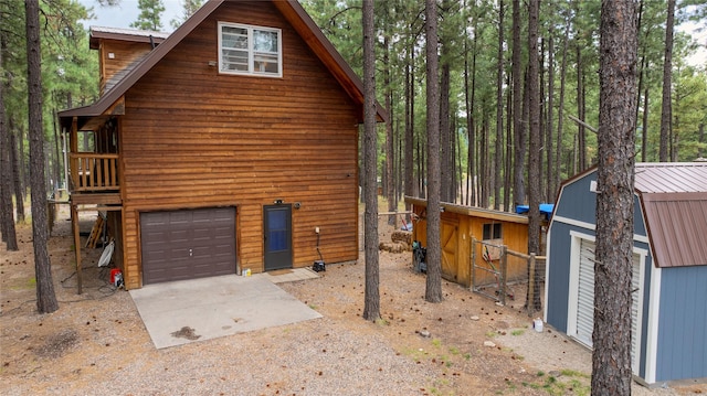 view of side of home with an outdoor structure and a garage