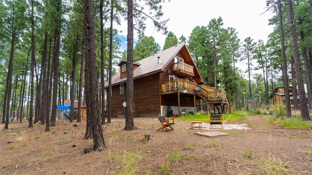 back of house featuring a wooden deck