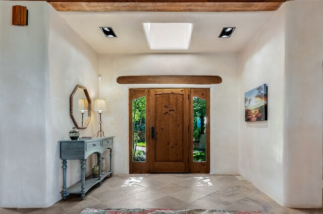 tiled living room with beamed ceiling, high vaulted ceiling, and wooden ceiling