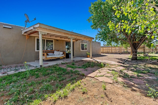 back of property with a patio area, fence, and stucco siding