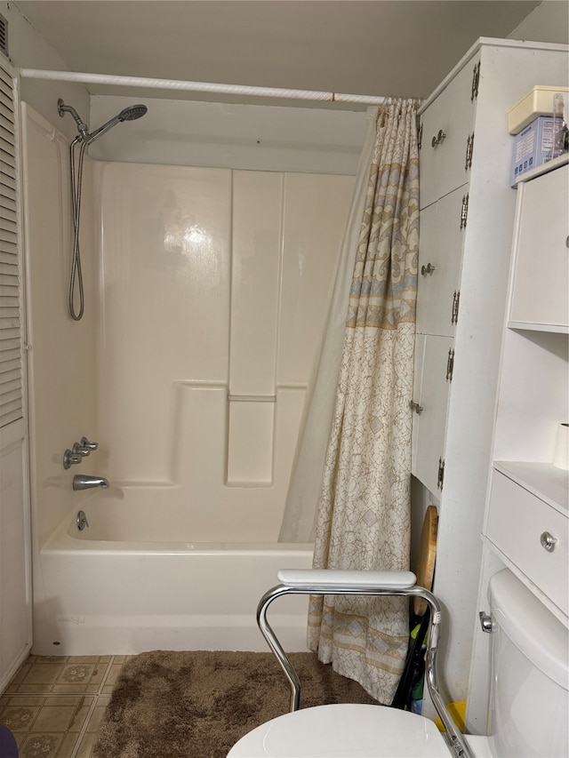 bathroom featuring toilet, shower / tub combo, and tile patterned flooring