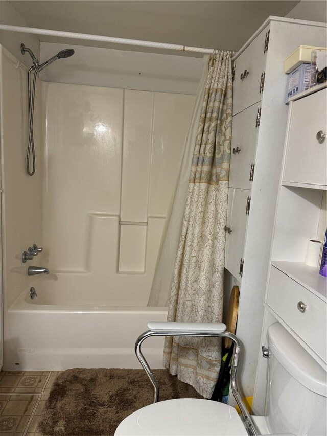 bathroom with toilet and shower / tub combo with curtain