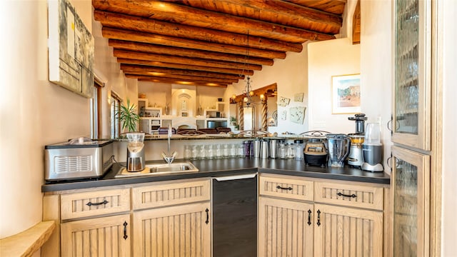 kitchen featuring beamed ceiling and light brown cabinetry