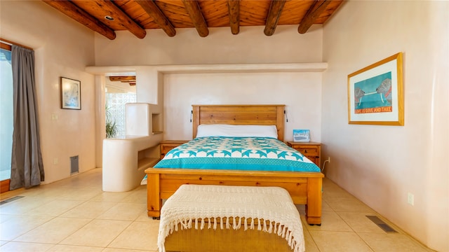 tiled bedroom with beamed ceiling and wooden ceiling