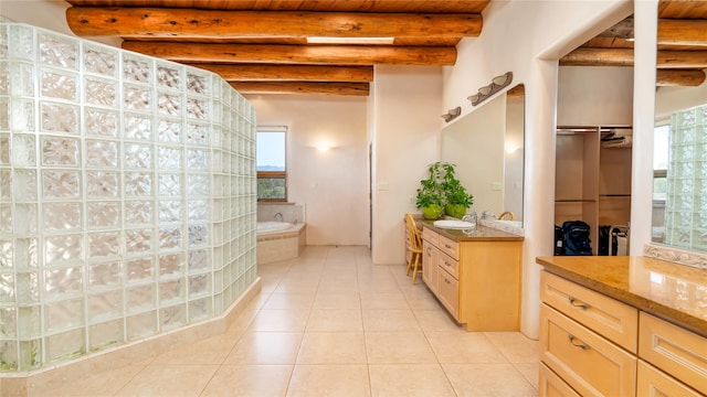 bathroom featuring vanity, beamed ceiling, tile patterned flooring, and a washtub