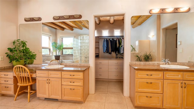 bathroom with tile patterned flooring, vanity, and beam ceiling