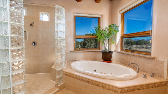 bathroom featuring plus walk in shower and tile patterned floors