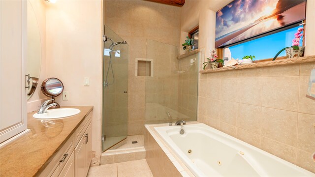 bathroom featuring plus walk in shower, tile patterned floors, and vanity