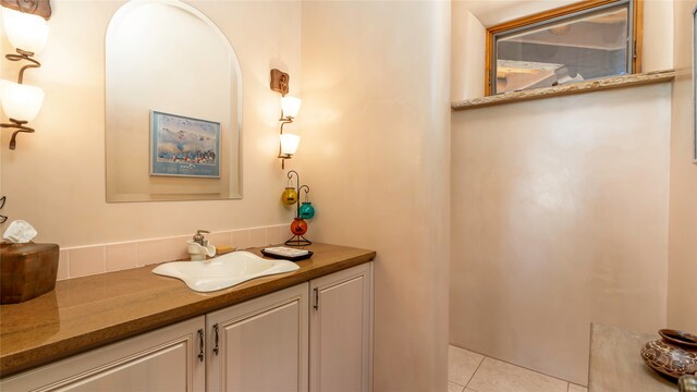 bathroom with tile patterned flooring and vanity