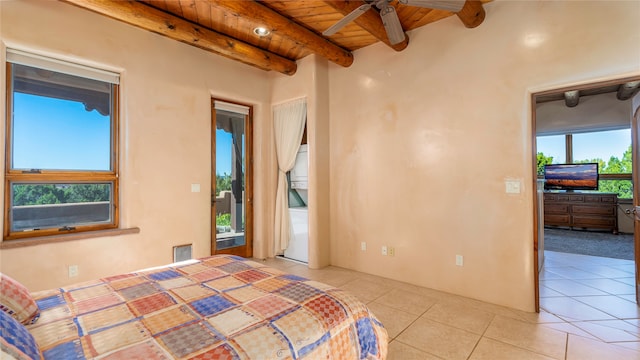 bedroom with wood ceiling, multiple windows, light tile patterned floors, and beam ceiling