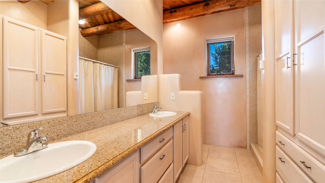 bathroom with vanity, curtained shower, beam ceiling, tile patterned flooring, and a healthy amount of sunlight