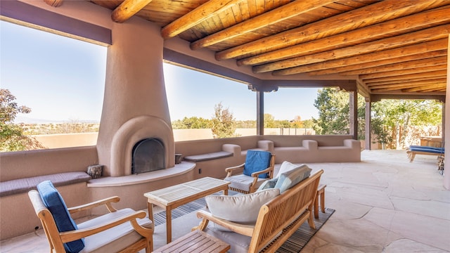 view of patio with an outdoor living space with a fireplace