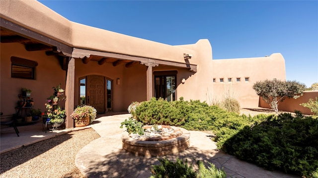 entrance to property with a patio