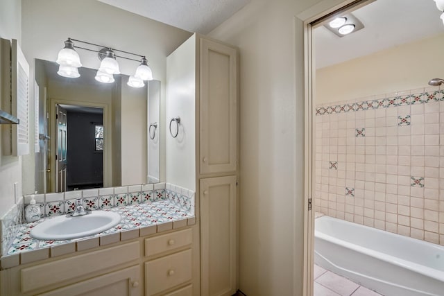 bathroom with tile patterned flooring, vanity, and bathtub / shower combination