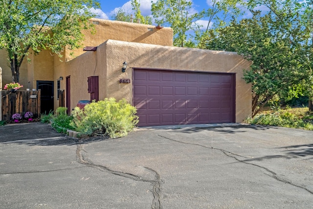 view of front of home with aphalt driveway, stucco siding, and a garage