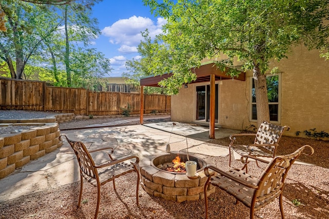 view of patio / terrace with a fire pit and a fenced backyard