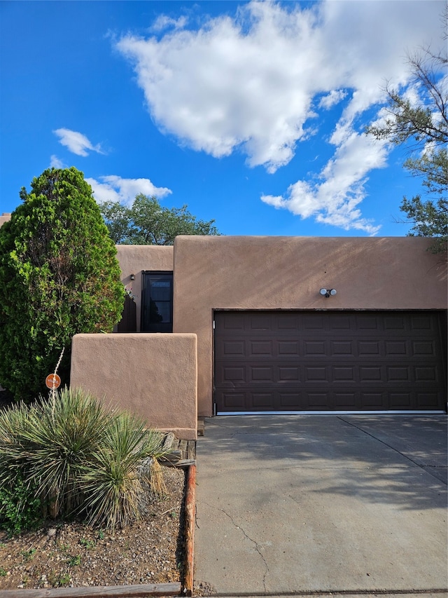 southwest-style home with a garage