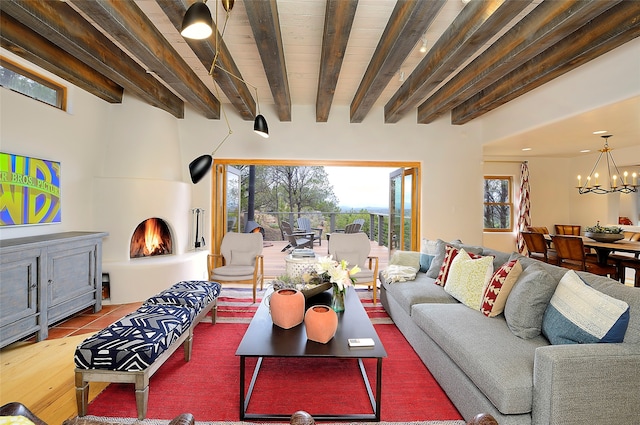 living room with beamed ceiling, light wood-type flooring, and a chandelier