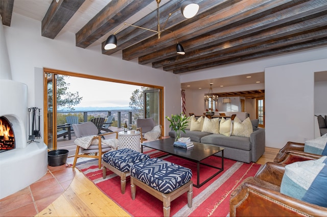 living room featuring a notable chandelier, tile patterned floors, and beam ceiling