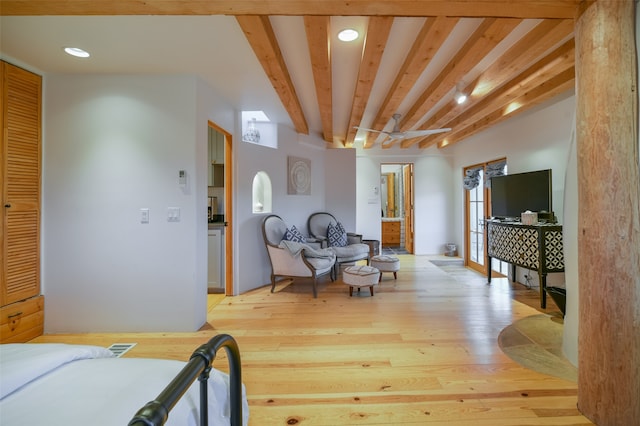 interior space with beamed ceiling and light hardwood / wood-style floors