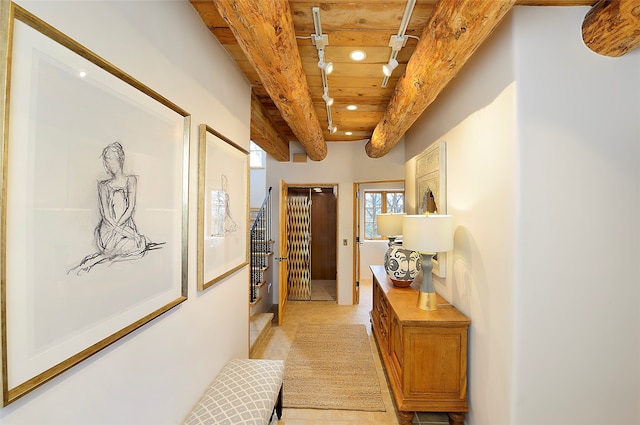 hallway with wood ceiling, light tile patterned floors, and beam ceiling