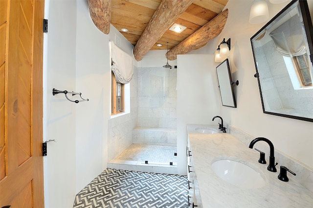 bathroom featuring wooden ceiling, vanity, beamed ceiling, and tiled shower