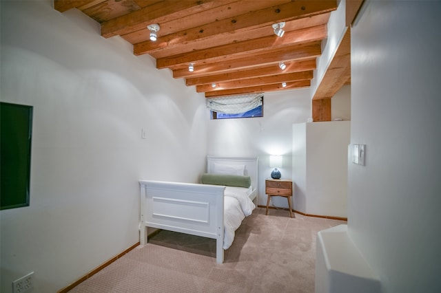 carpeted bedroom featuring beam ceiling