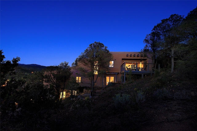 view of back house at dusk