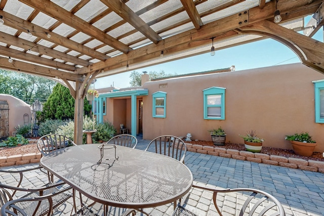 view of patio featuring outdoor dining space and a pergola