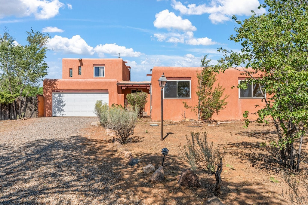 pueblo-style house with a garage