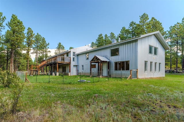back of property featuring a lawn, stairs, and a deck