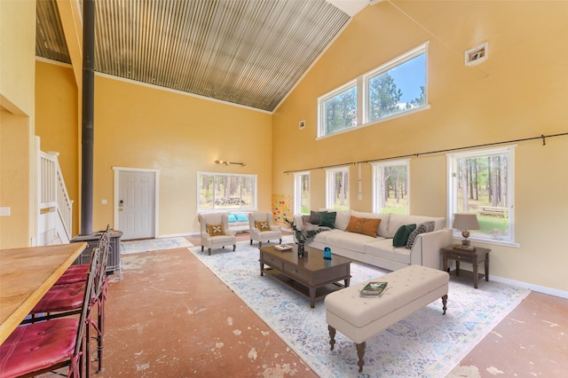 carpeted living room featuring a healthy amount of sunlight and high vaulted ceiling