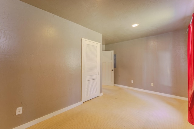 unfurnished room featuring light carpet