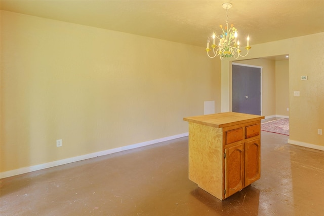 interior space featuring concrete floors and a notable chandelier