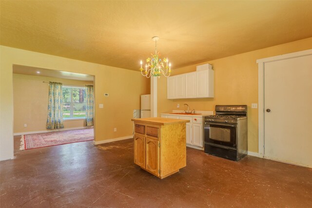 kitchen with black gas stove, white cabinets, pendant lighting, and white refrigerator