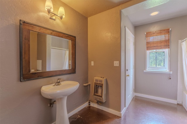 bathroom featuring a shower with shower curtain, concrete flooring, sink, and heating unit