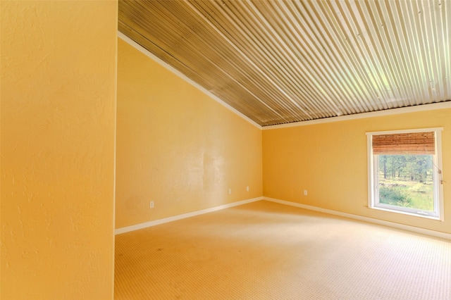 unfurnished room with lofted ceiling, ornamental molding, and carpet floors