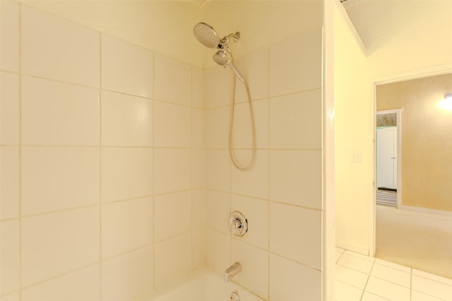 bathroom featuring tile patterned floors and tiled shower / bath combo