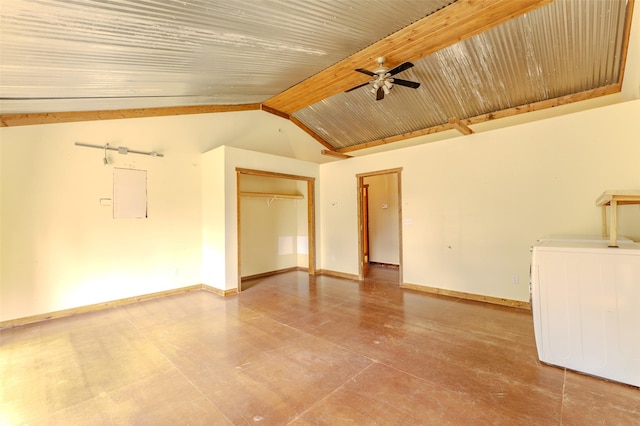 unfurnished living room featuring vaulted ceiling with beams, ceiling fan, washer / dryer, and electric panel