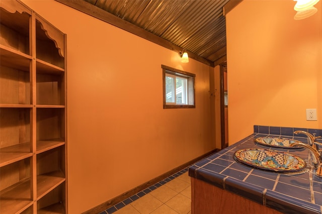 interior space featuring light tile patterned flooring and wood ceiling