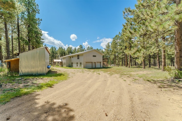 exterior space featuring an outbuilding and a garage