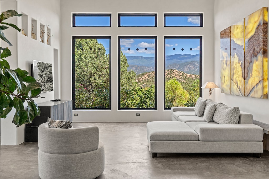 living area with concrete floors and a mountain view