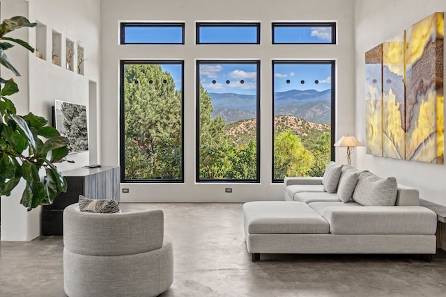 living area with concrete floors and a mountain view