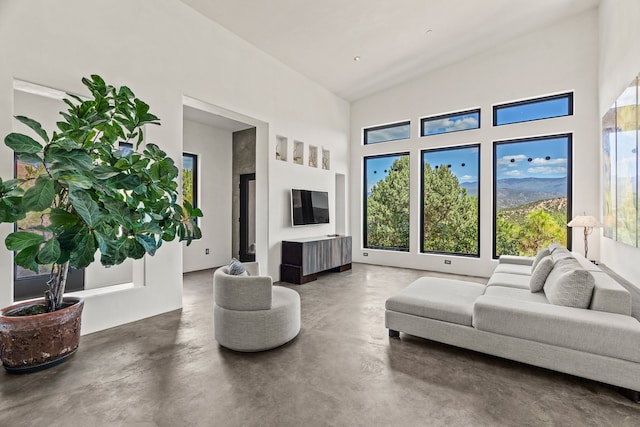 living room with high vaulted ceiling and plenty of natural light