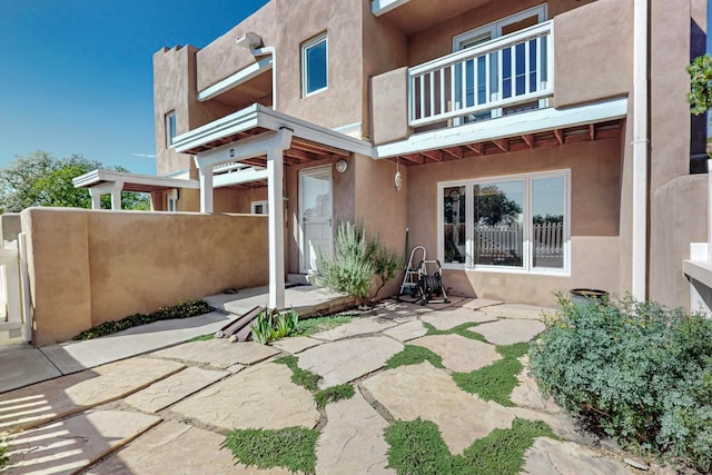 view of patio featuring a balcony