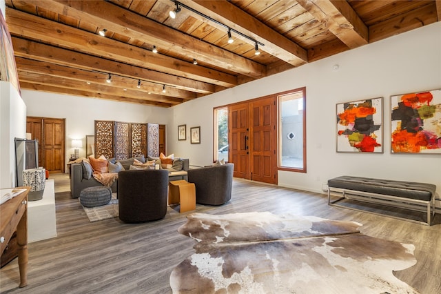 living room featuring beamed ceiling, hardwood / wood-style floors, and wooden ceiling