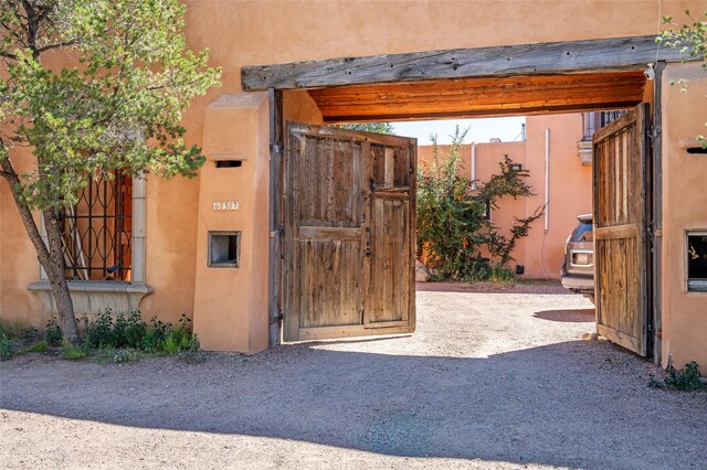 637 Alto St Unit A, Santa Fe, NM 87501 - living area with light wood-style floors, wine cooler, track lighting, wood ceiling, and stacked washer and dryer