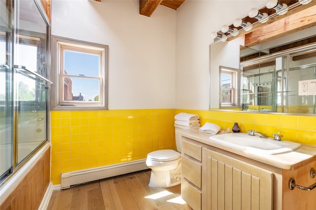 full bathroom featuring hardwood / wood-style floors, enclosed tub / shower combo, vanity, a baseboard heating unit, and toilet